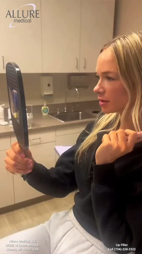 A woman with blonde hair examines her reflection in a handheld mirror in a clinical setting at Allure Medical, with contact details and services listed at the bottom of the image.