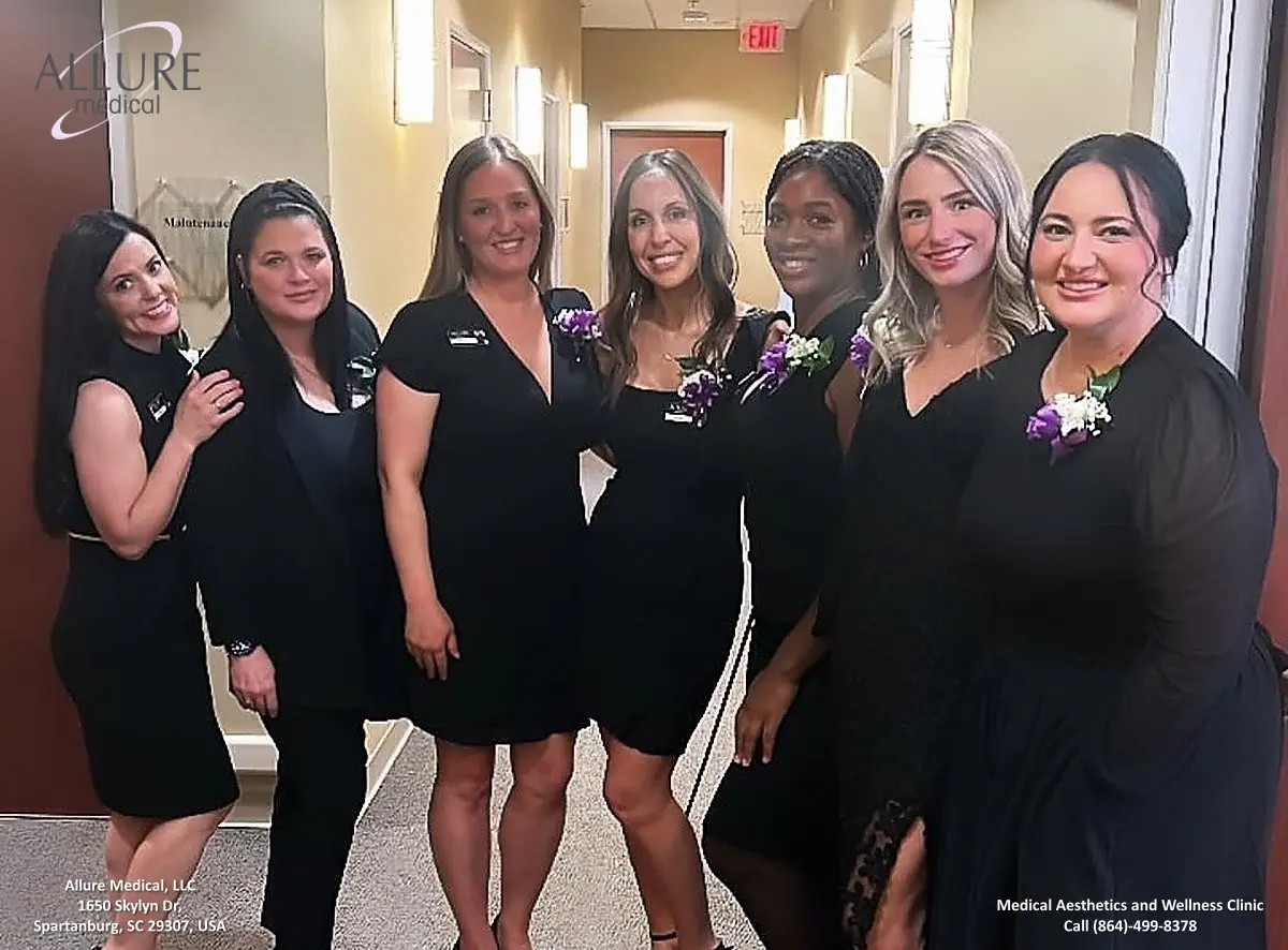 Six women in black dresses standing in a hallway and smiling at the camera. They appear to be part of a medical aesthetics and wellness clinic. The clinic's name and contact information are visible on the image.