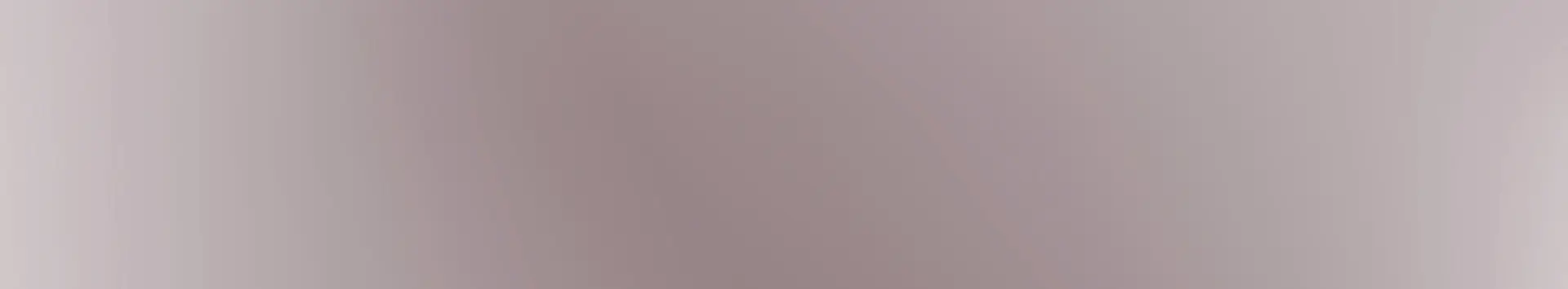 A blurred gradient background with soft pink and gray tones.